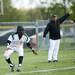 Huron High School Demetrius Sims attempts to dodge an out between third and home plate during the first game against Pioneer on Monday, May 13. Daniel Brenner I AnnArbor.com
